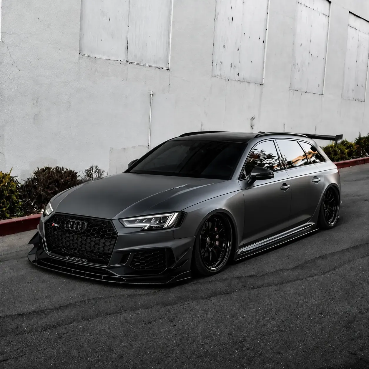 A four-door wagon in a satin gray color-change wrap, shot from the front quarter